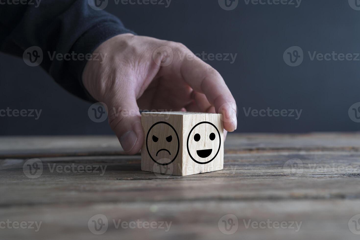 Hand touch select smile face emotion of wooden cube block. Rating concept. choice of happy positive symbol. photo
