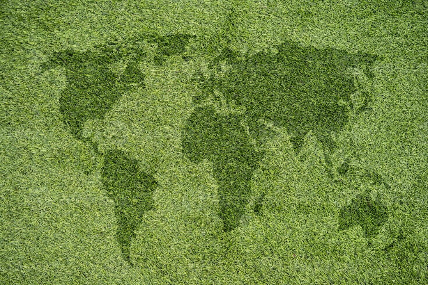 World map on green grass lawn background for global eco-friendly environment, ecological and environmental saving, earth day. photo
