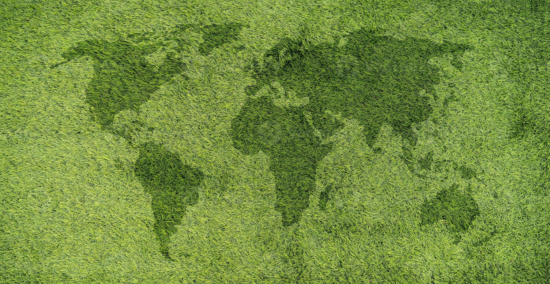 World map on green grass lawn background for global eco-friendly environment, ecological and environmental saving, earth day photo