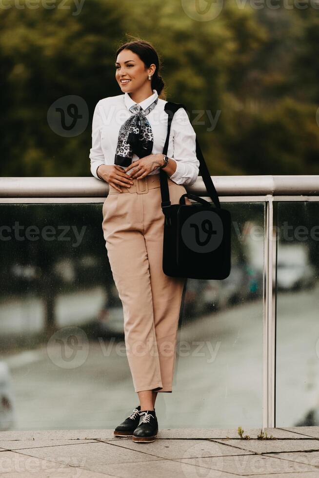 Smiling Latina businesswoman strides confidently through urban streets. photo
