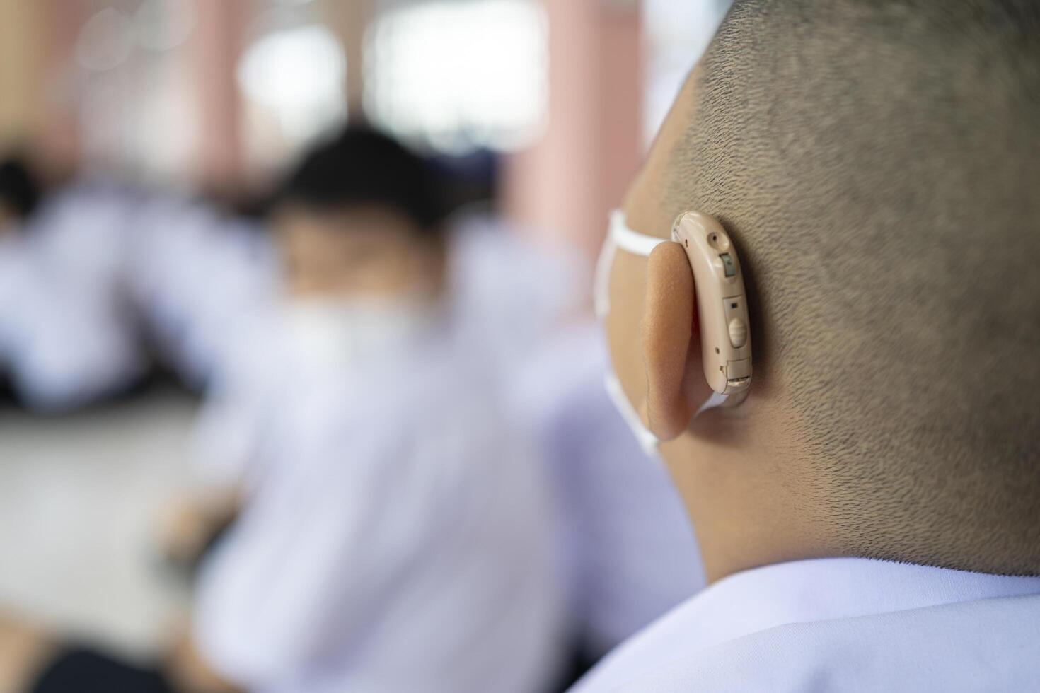 A child with a hearing aid. The boy assumes hearing aid. photo