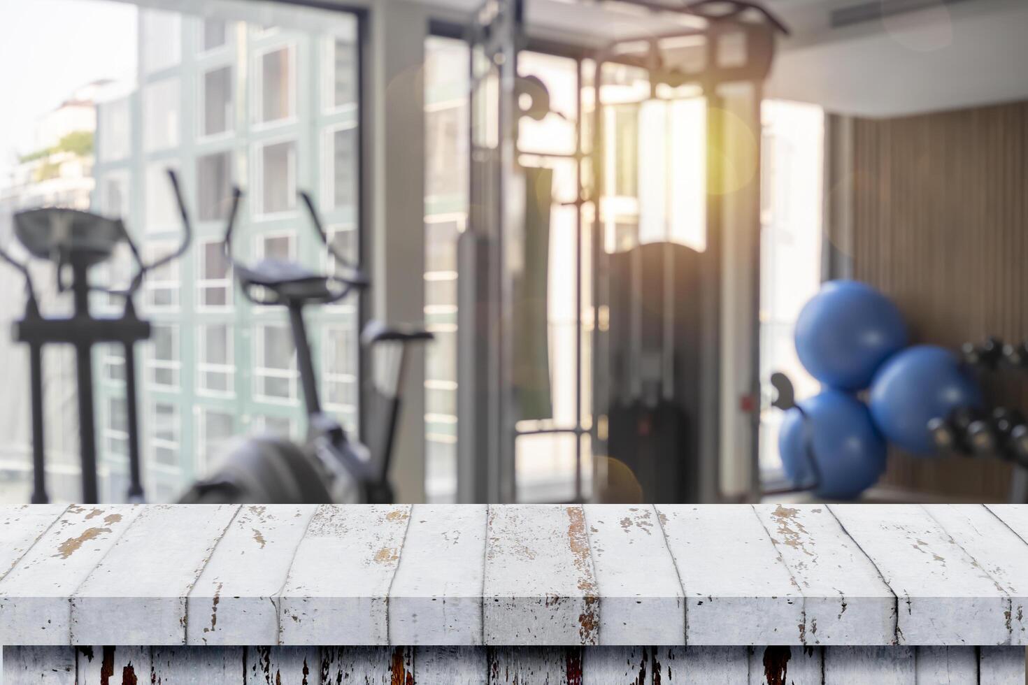 Table top and Blurred of fitness gym background for banner photo