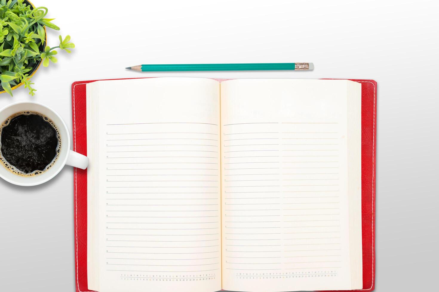 Top view blank paper Notebook, flowers, cup of coffee and pen. Desktop mock up, Flat lay of green working table background photo
