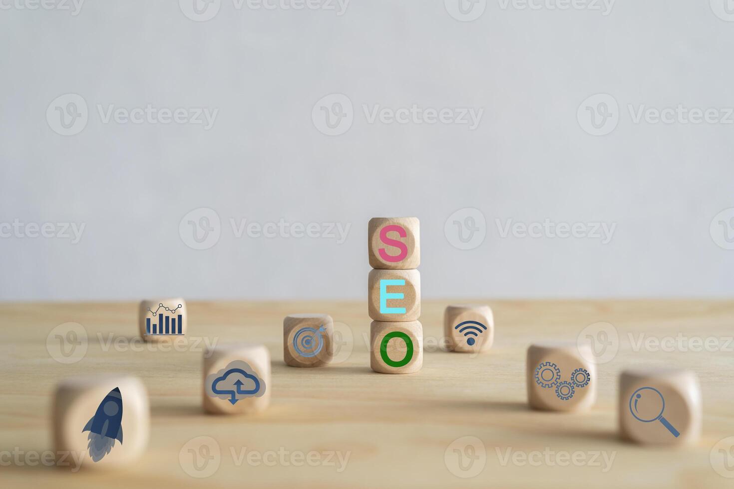 A cube-shaped wooden block sits on a desk with the word SEO. photo