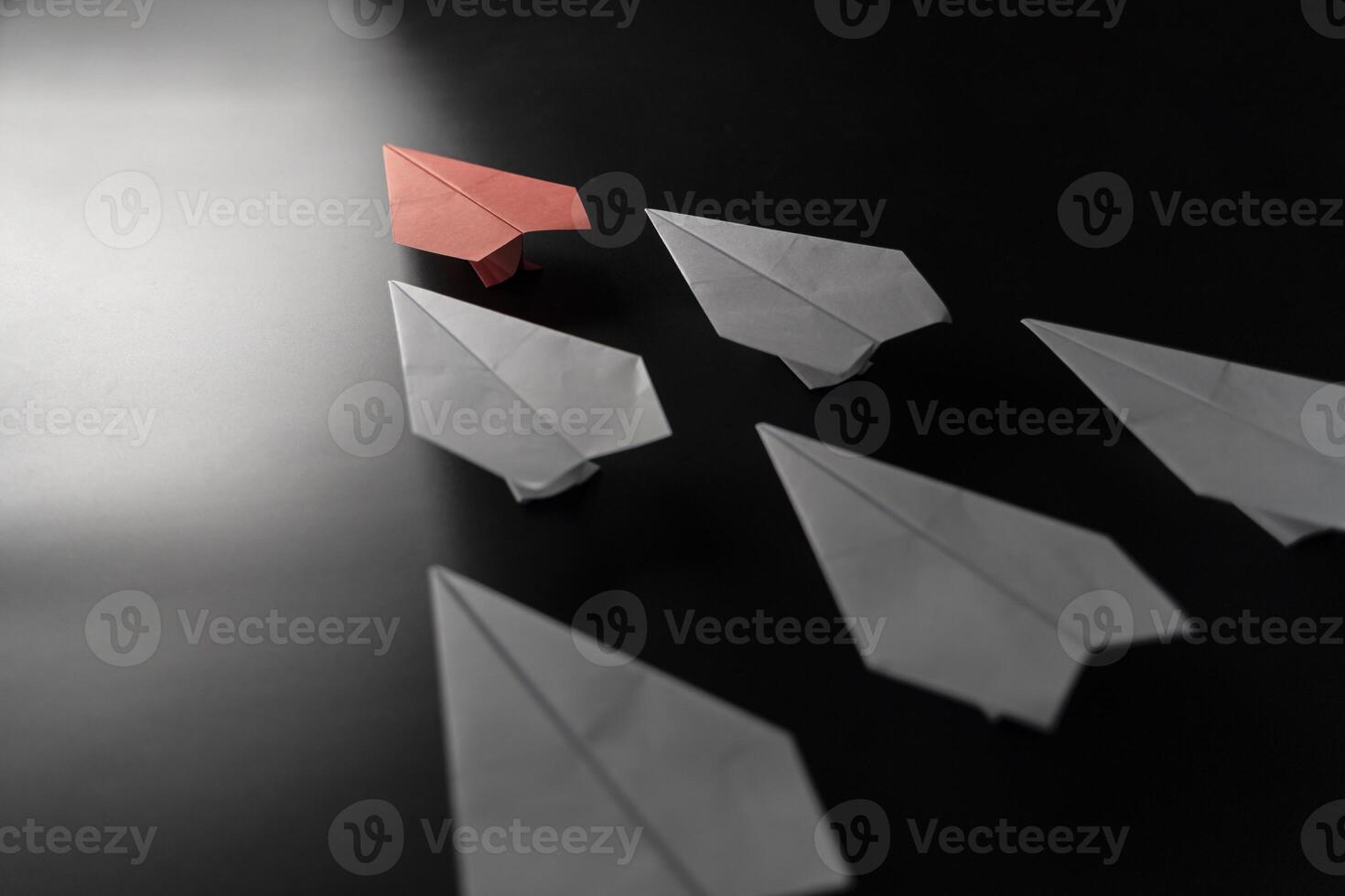 Different thinking concept. Red paper plane leaving the group. Red paper plane leading white ones photo