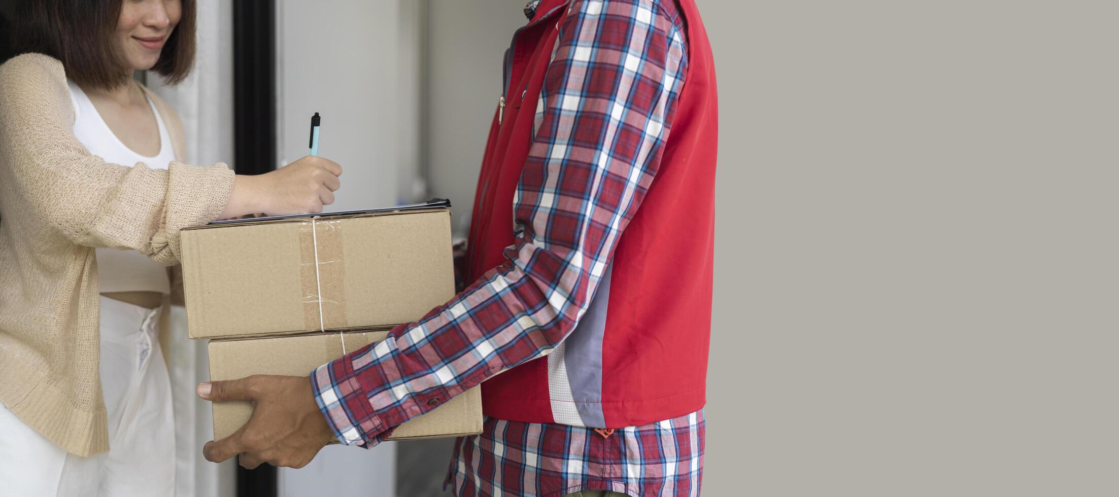 Woman signing receipt of delivery package, close up photo