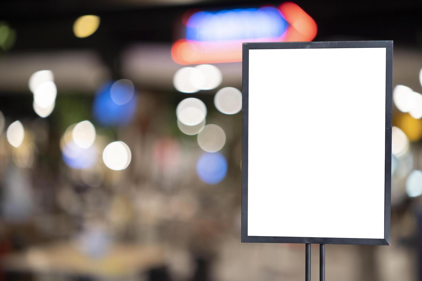 mockup white poster with black frame stand in front of blur restaurant cafe background for show photo