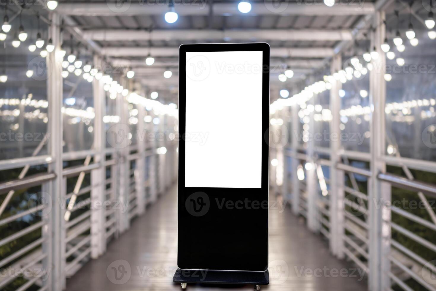 A large vertical blank billboard is mounted on the walkway photo