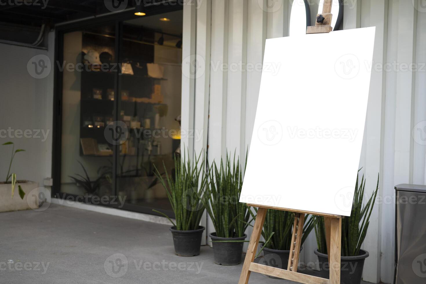 The white blank sheet is placed on located in front of a coffee shop photo