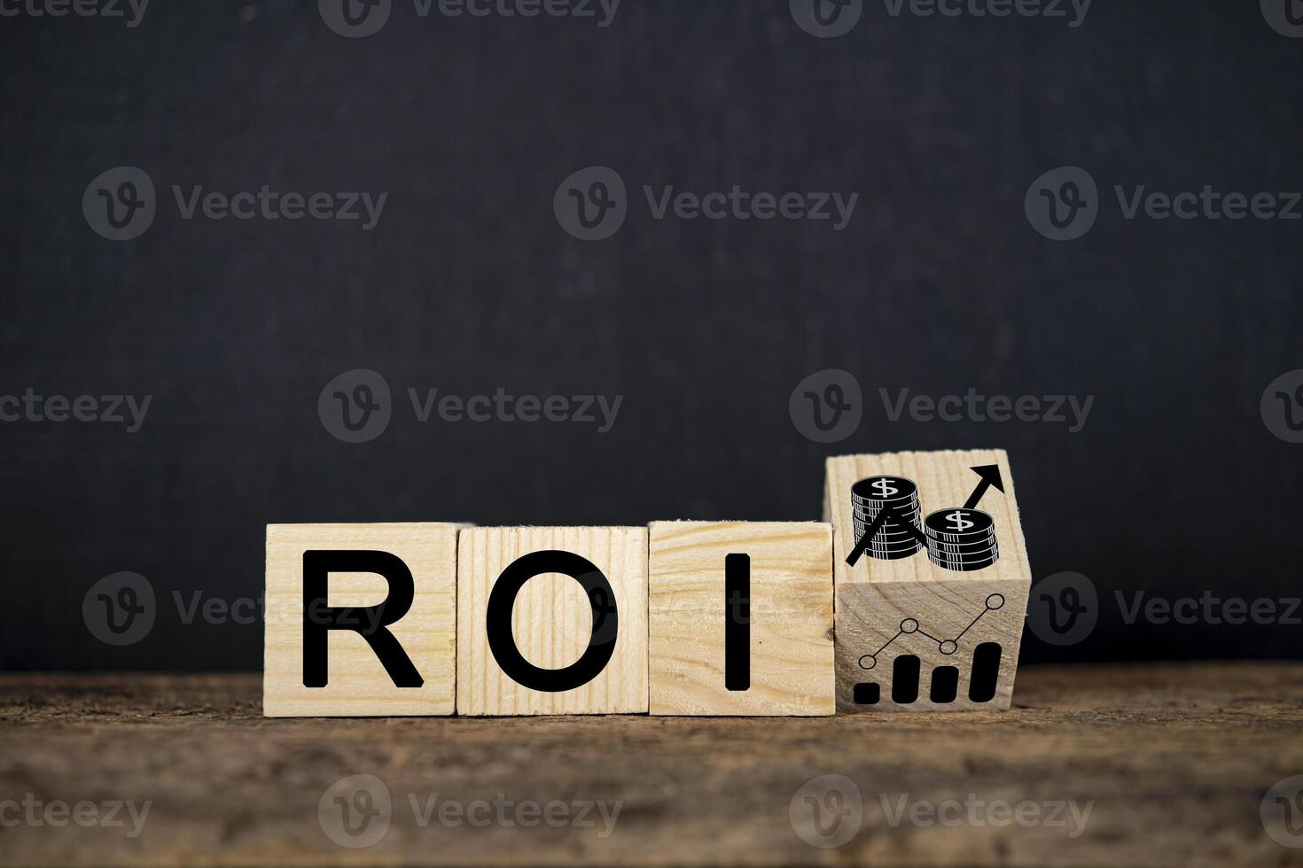 Wooden block with growth icon and ROI text isolated on black background. photo