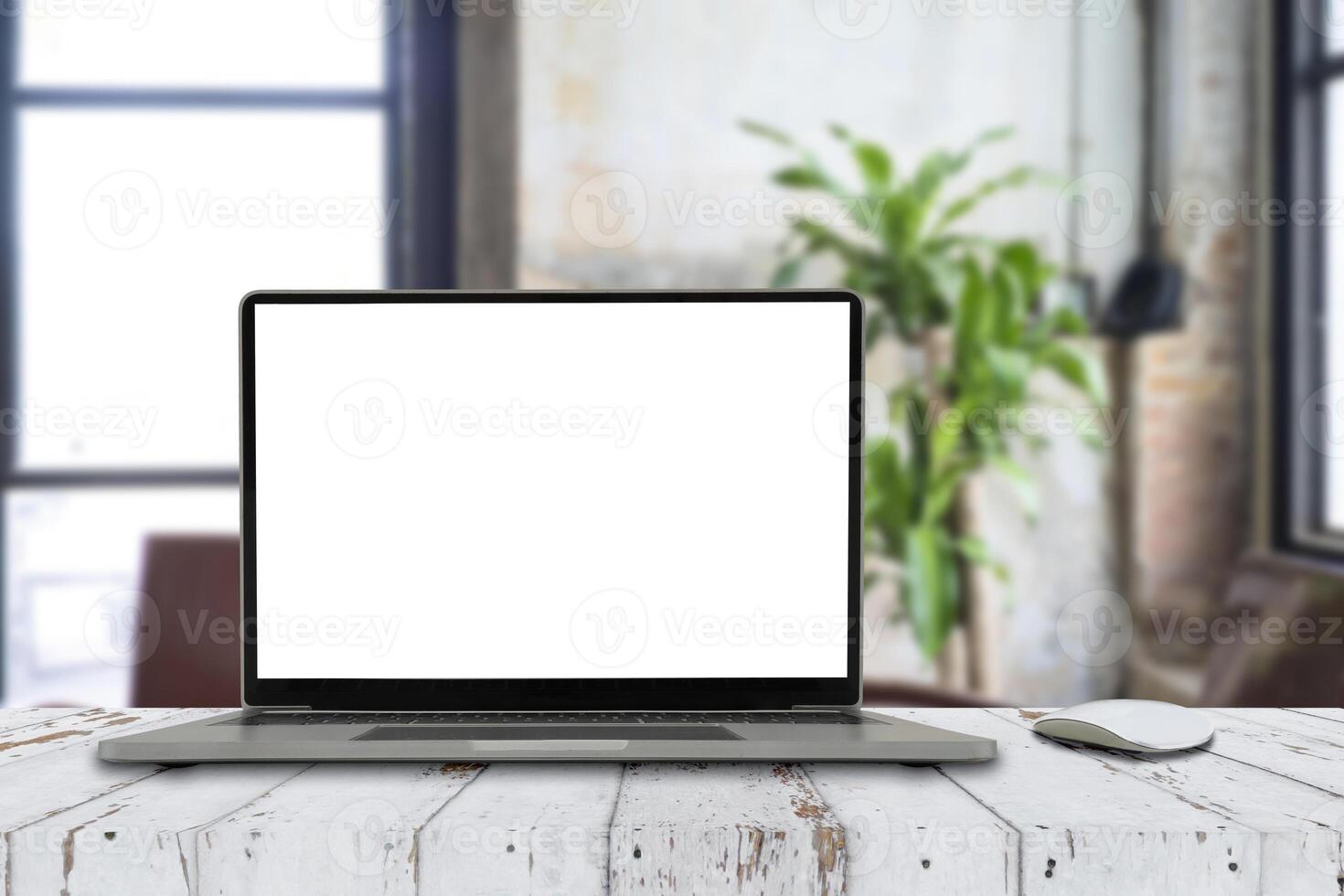 Laptop with blank screen on white table with mouse. photo