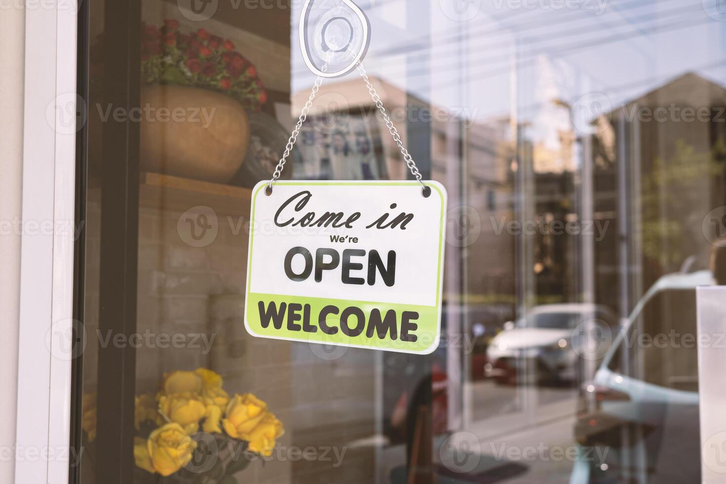 Open sign broad through the glass of door in cafe photo
