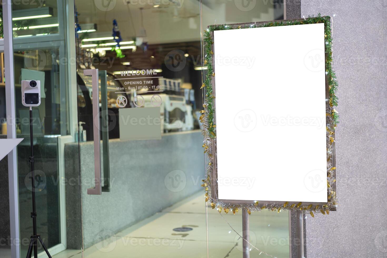White poster mockup with black frame stand in front of blurred cafe restaurant background photo
