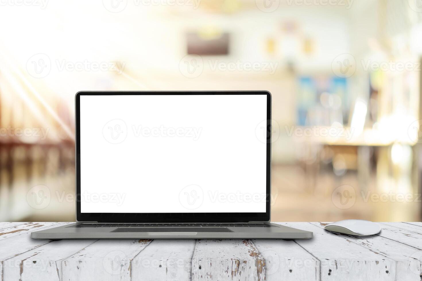 Notebook computer on the table with blank screen on classroom background photo