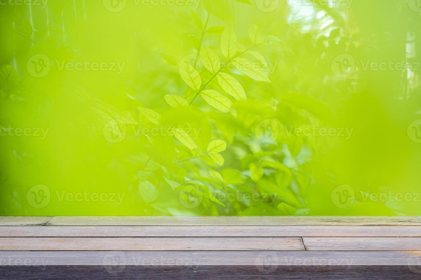 image of wooden table in front of abstract blurred background of outdoor garden lights. photo