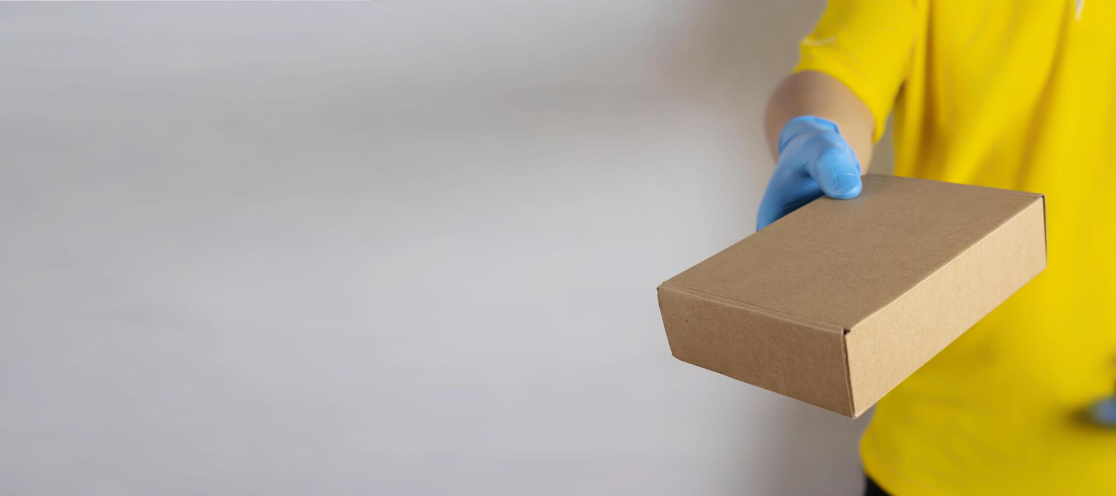 Delivery man holding cardboard boxes photo