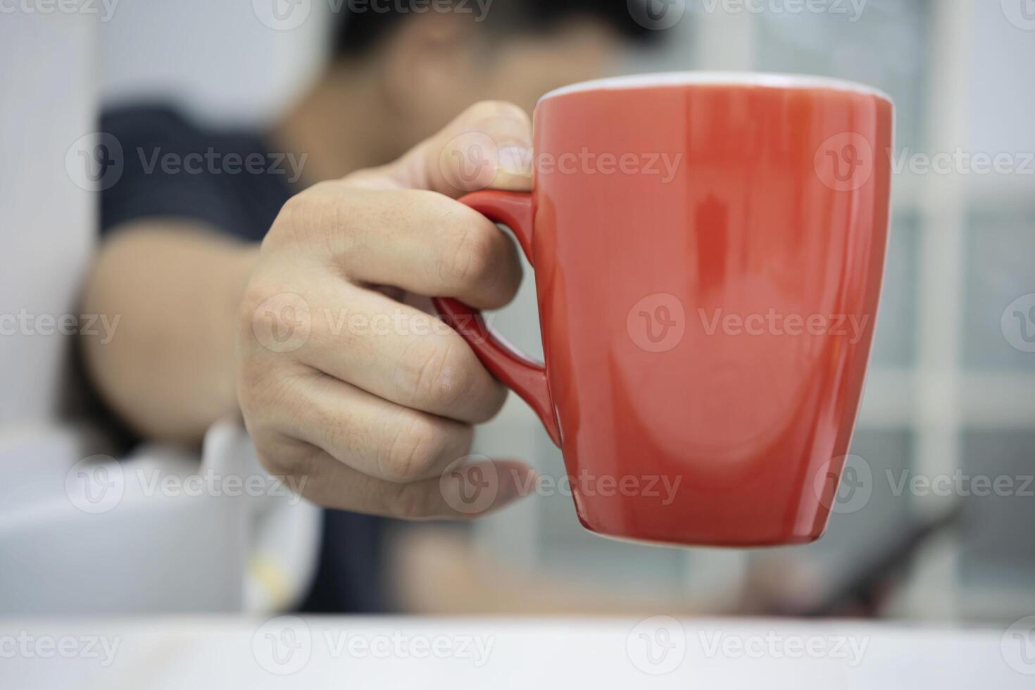 man sits on the toilet at home in the morning while drinking coffee. photo