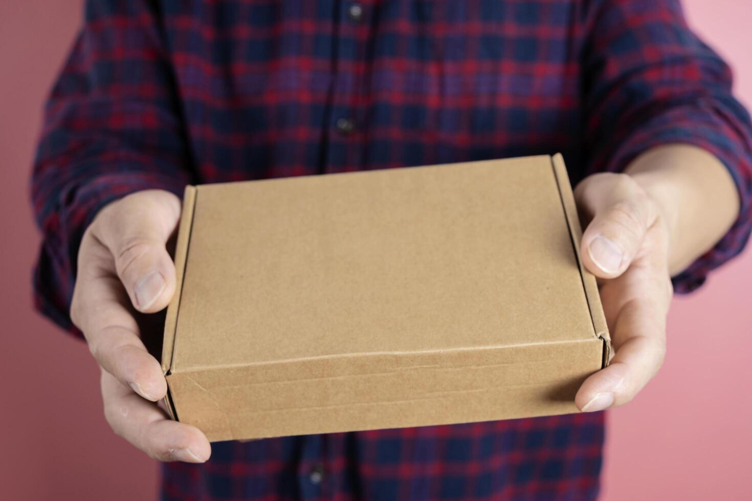 delivery man carrying cardboard parcel with label with copy space. photo