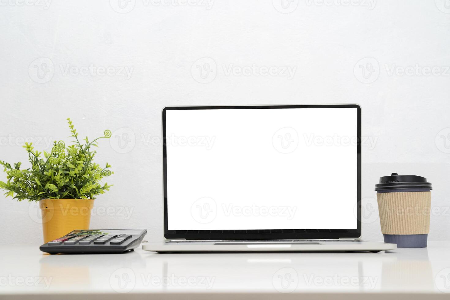 Laptop computer with blank screen in office photo