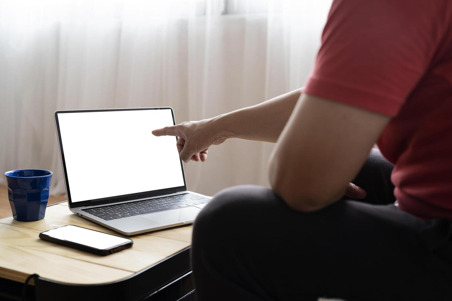 Close up back view of male employer sit at desk using modern laptop and smartphone gadget photo