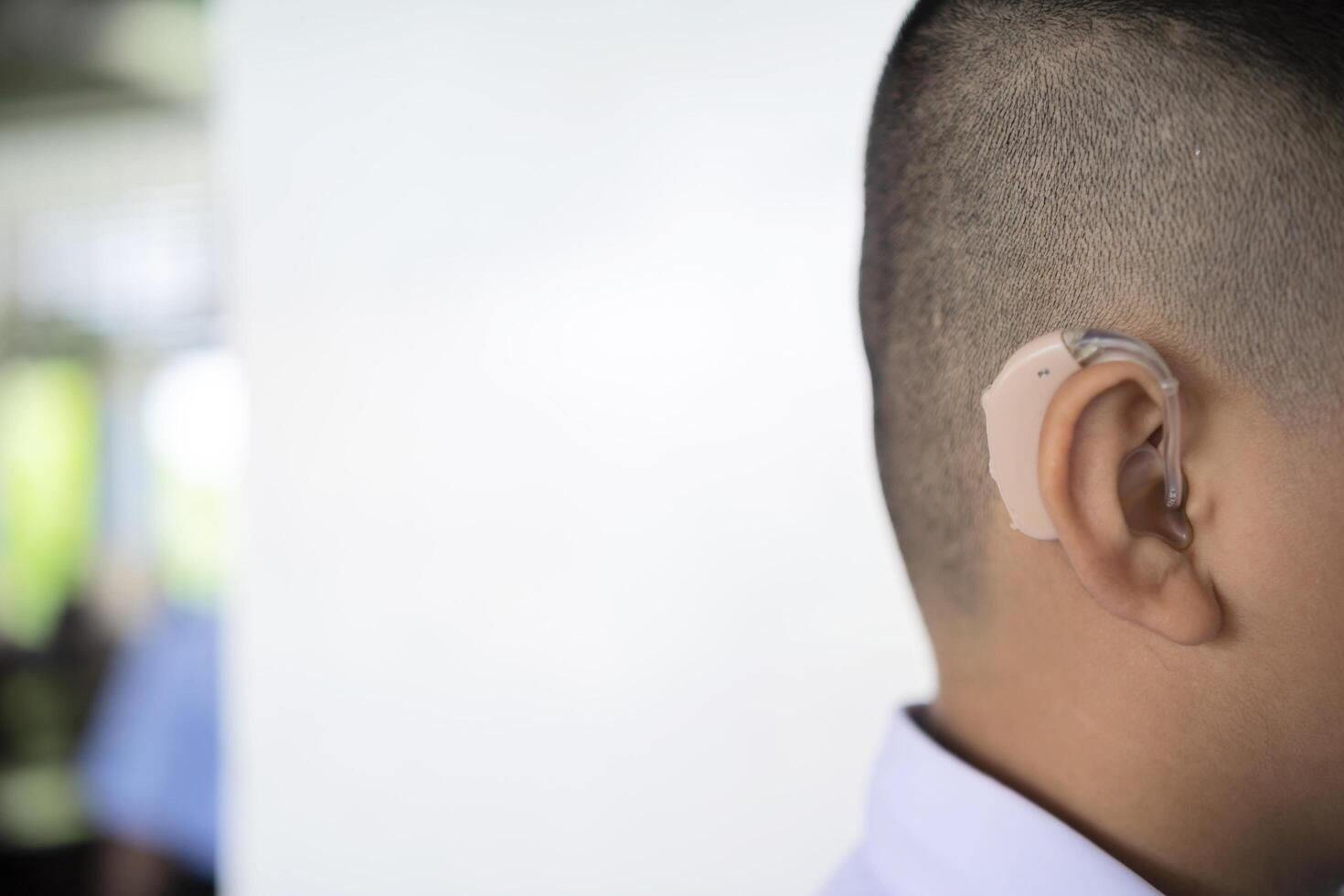 cute asian boy with hearing aids on school photo