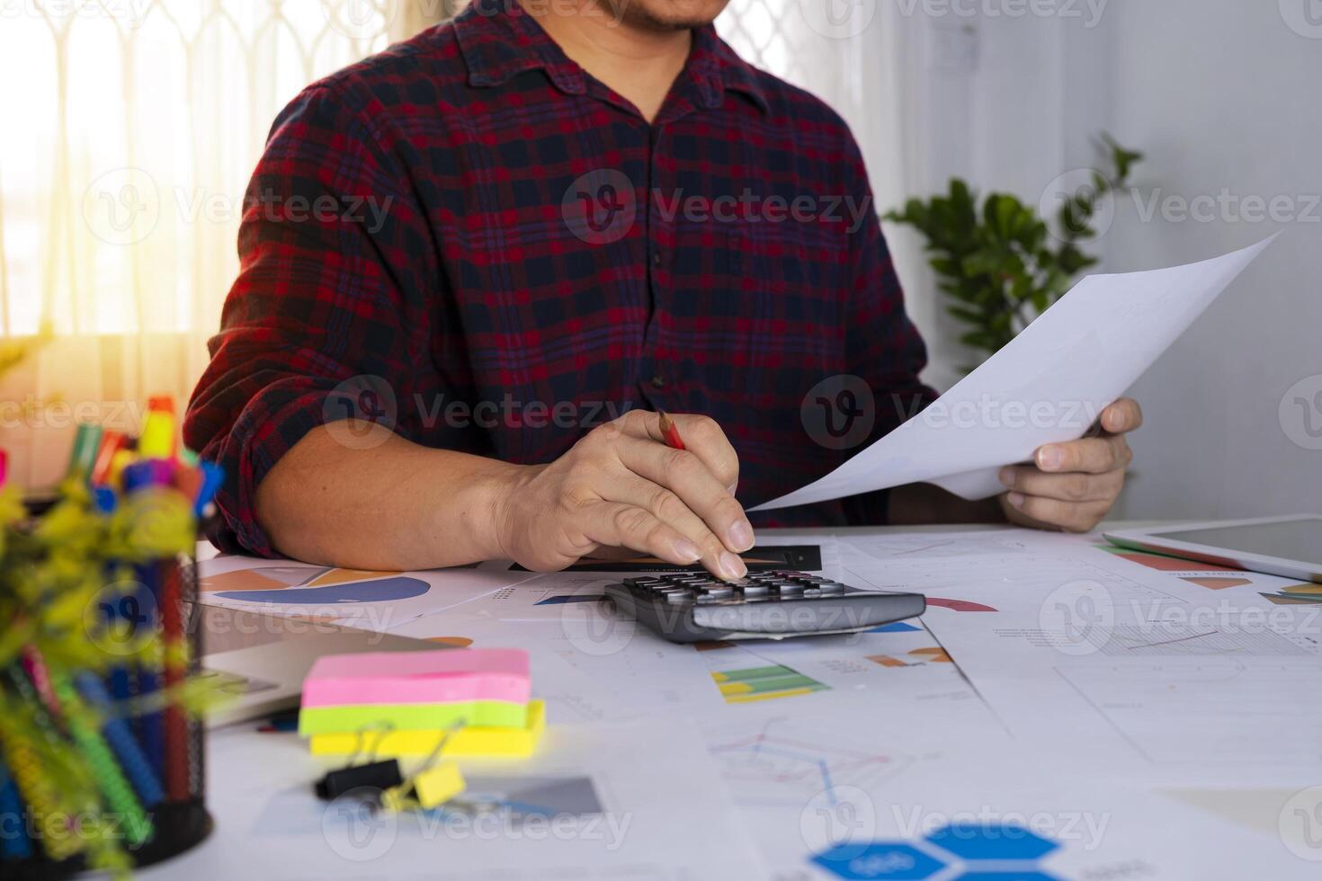 Businessmen are analyzing graphs at the desk. photo