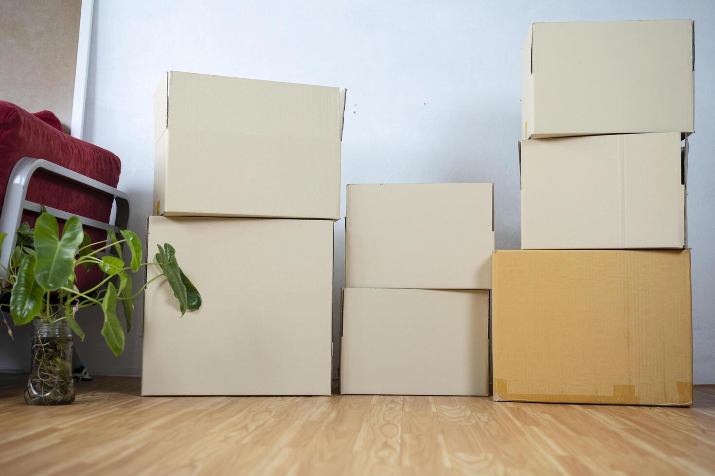 Moving boxes with belongings in empty room photo