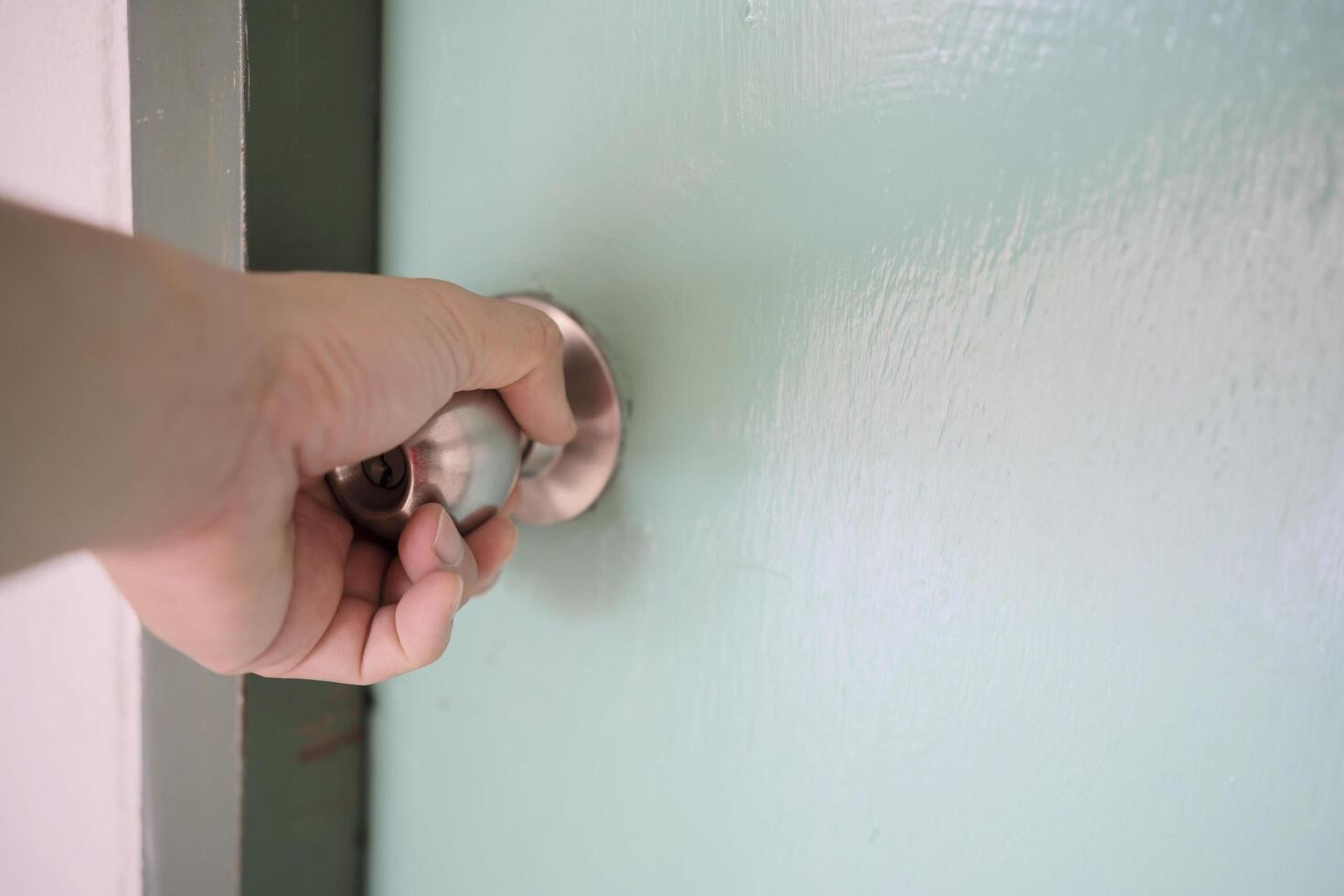 close up man hand holding a door knob photo