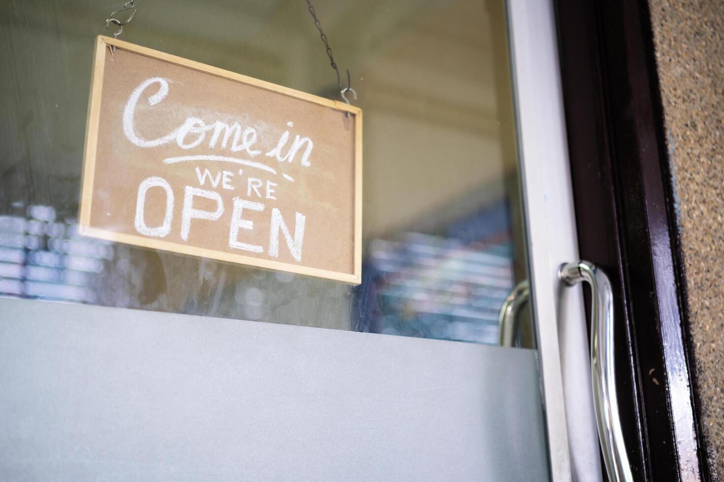 Come in we're open, vintage retro sign in cafe front photo