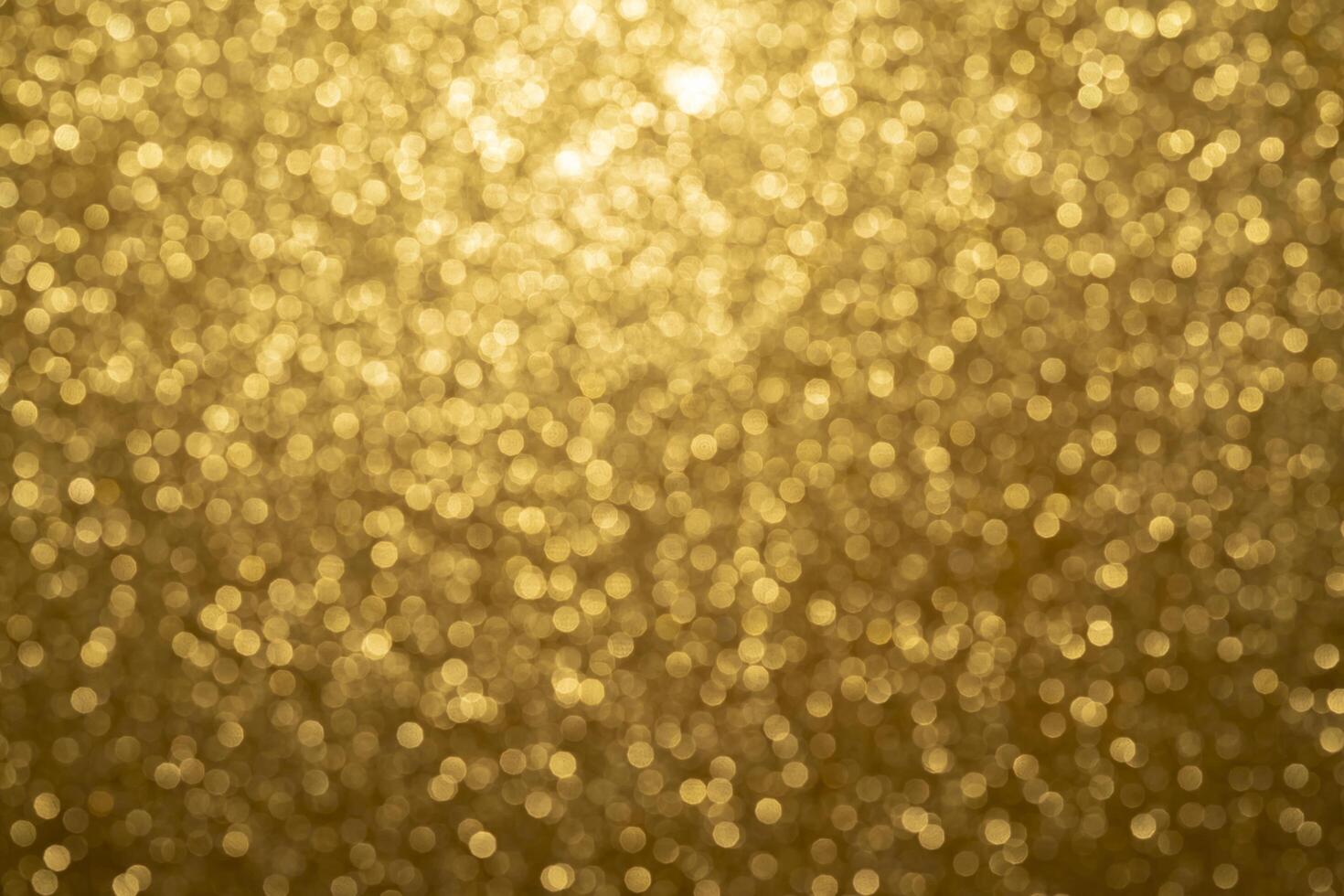 Abstract twinkled bright background with bokeh defocused golden lights photo