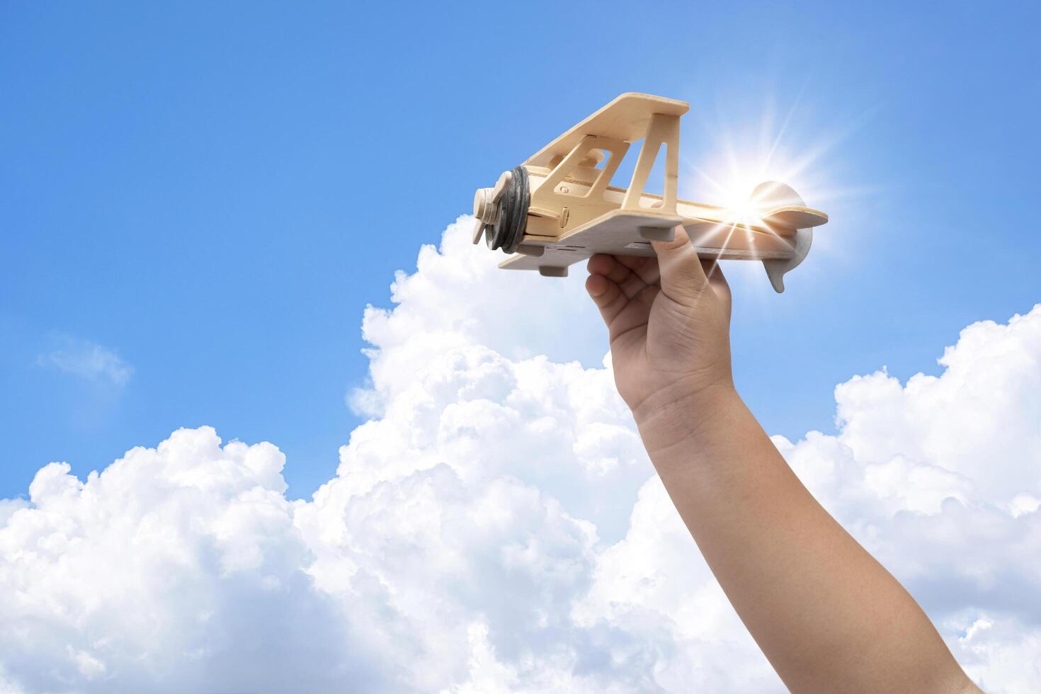 Toy balsa wood airplane in the sky photo
