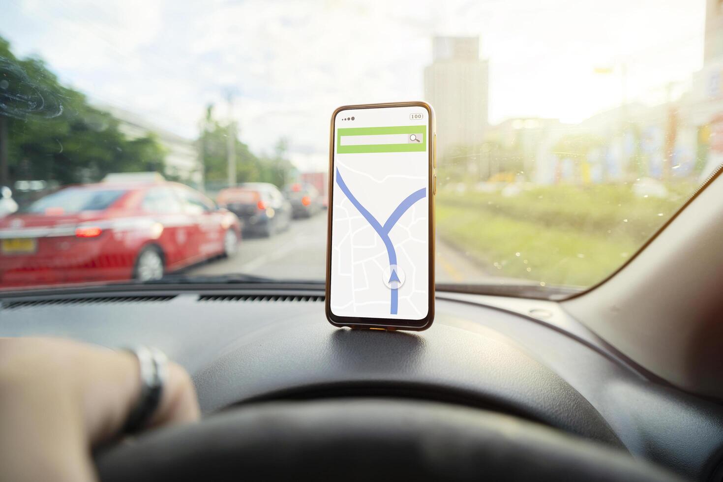 smartphone placed on the dashboard with a navigation map to help. photo