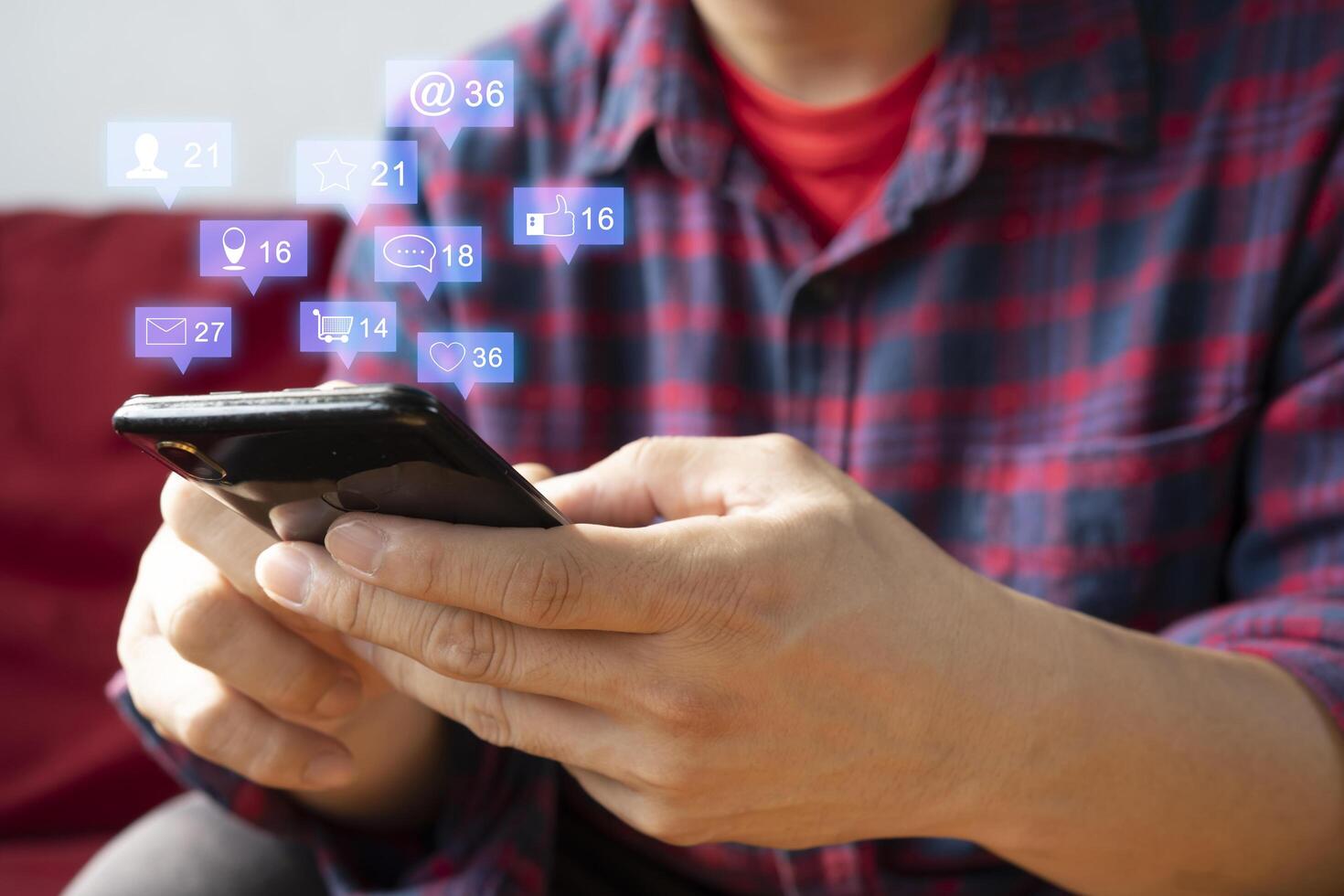 man hand using smartphone with colorful application icons around photo