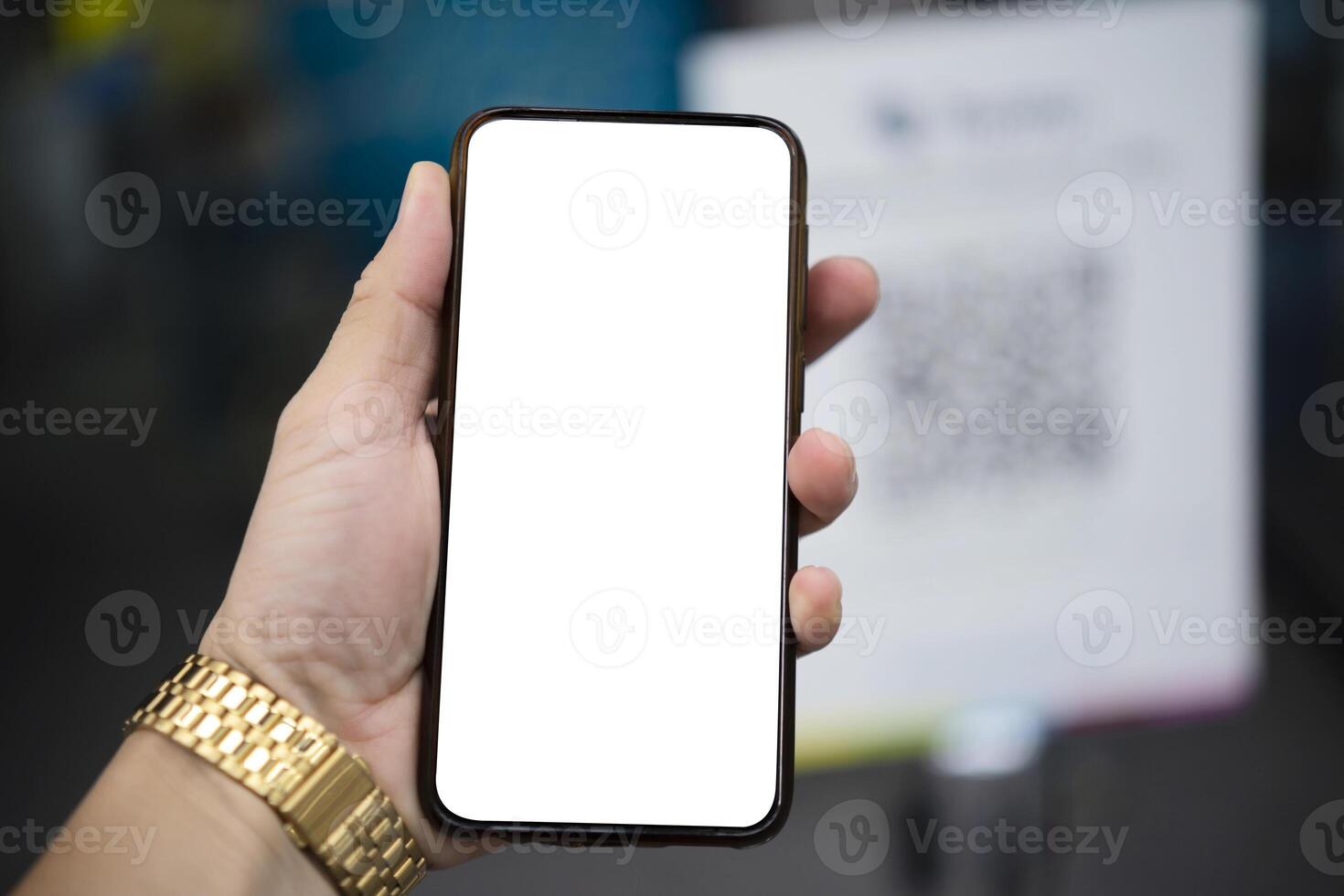 Mockup image of hand holding white mobile phone with blank white screen photo