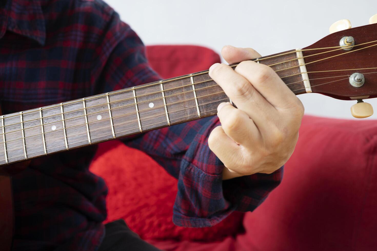Close up of man hand playing guitar. photo