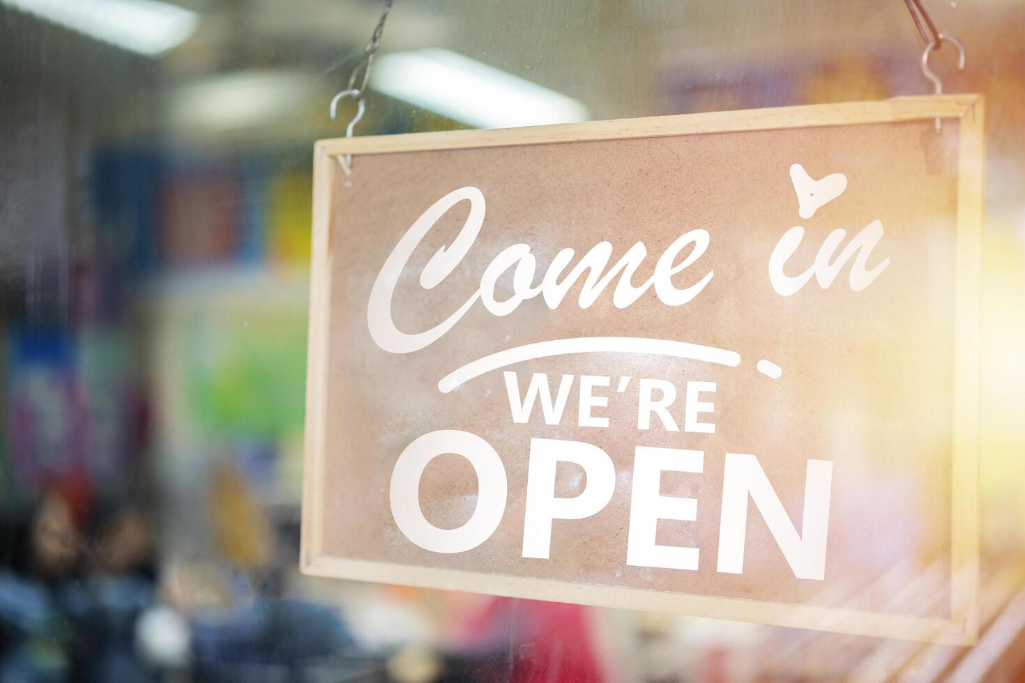 Come in we're open, vintage retro sign in cafe front photo