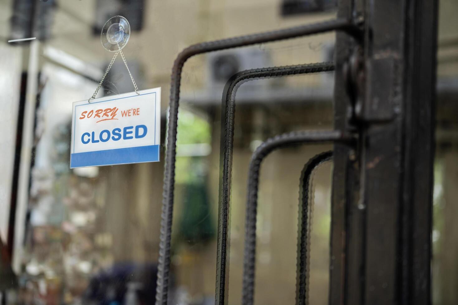 closed sign. grunge image hanging on a dirty glass door. photo