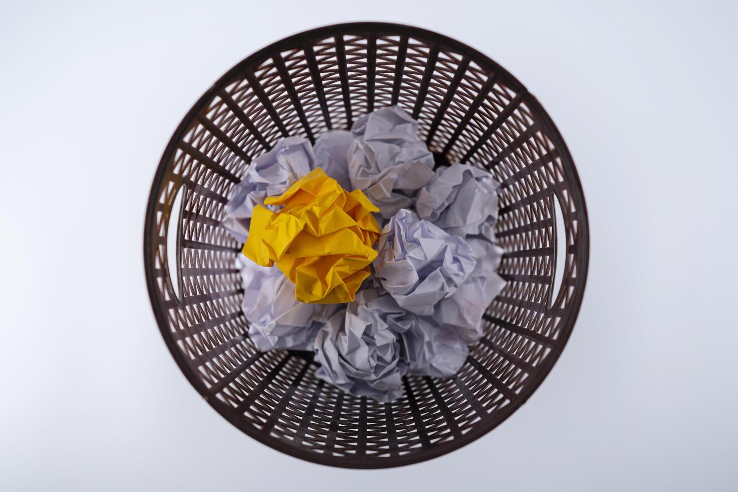 The yellow crumpled paper that was thrown into the trash As if you were throwing away a good idea photo