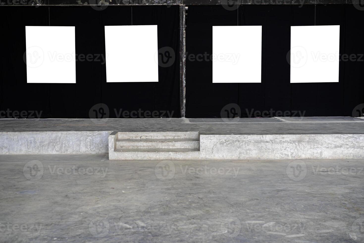 Four white picture frames were hung in a gallery photo