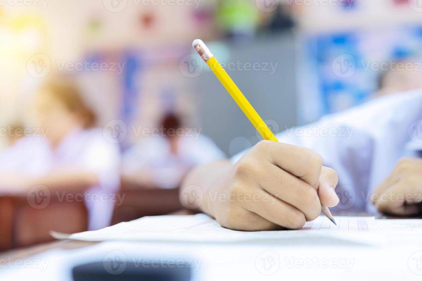 hand reading and writing notes on sheets of white paper, taking exam concept photo