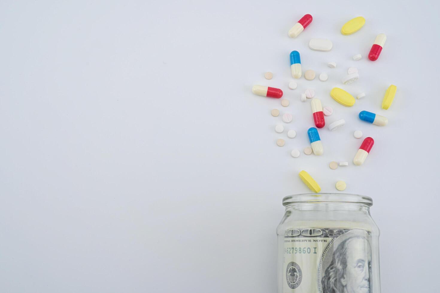 Dollar bills in a medicine box on a gray background photo
