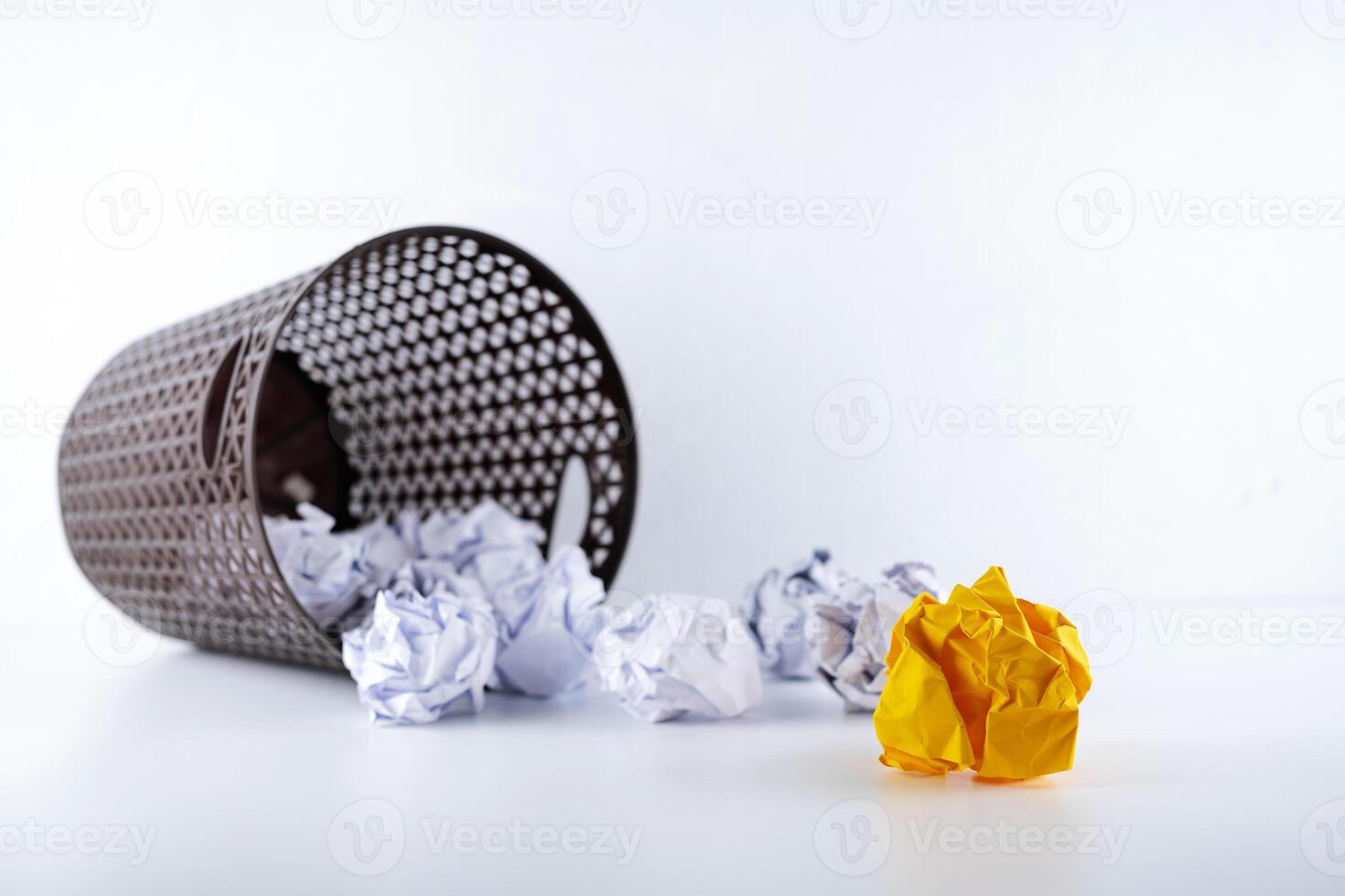 different orange crumpled paper ball on a white background photo