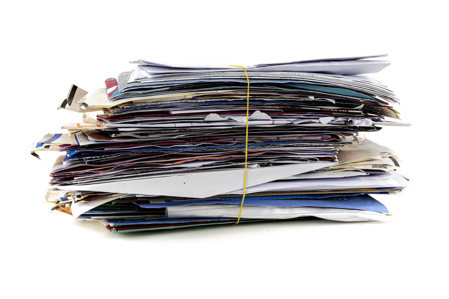 Junk mail stacked high of unpaid bills closeup white isolated background. photo