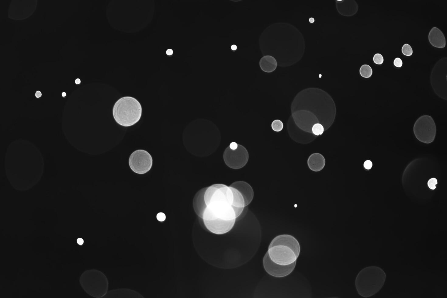 Abstract elegant glitter sparkle white bokeh abstract on Black background photo
