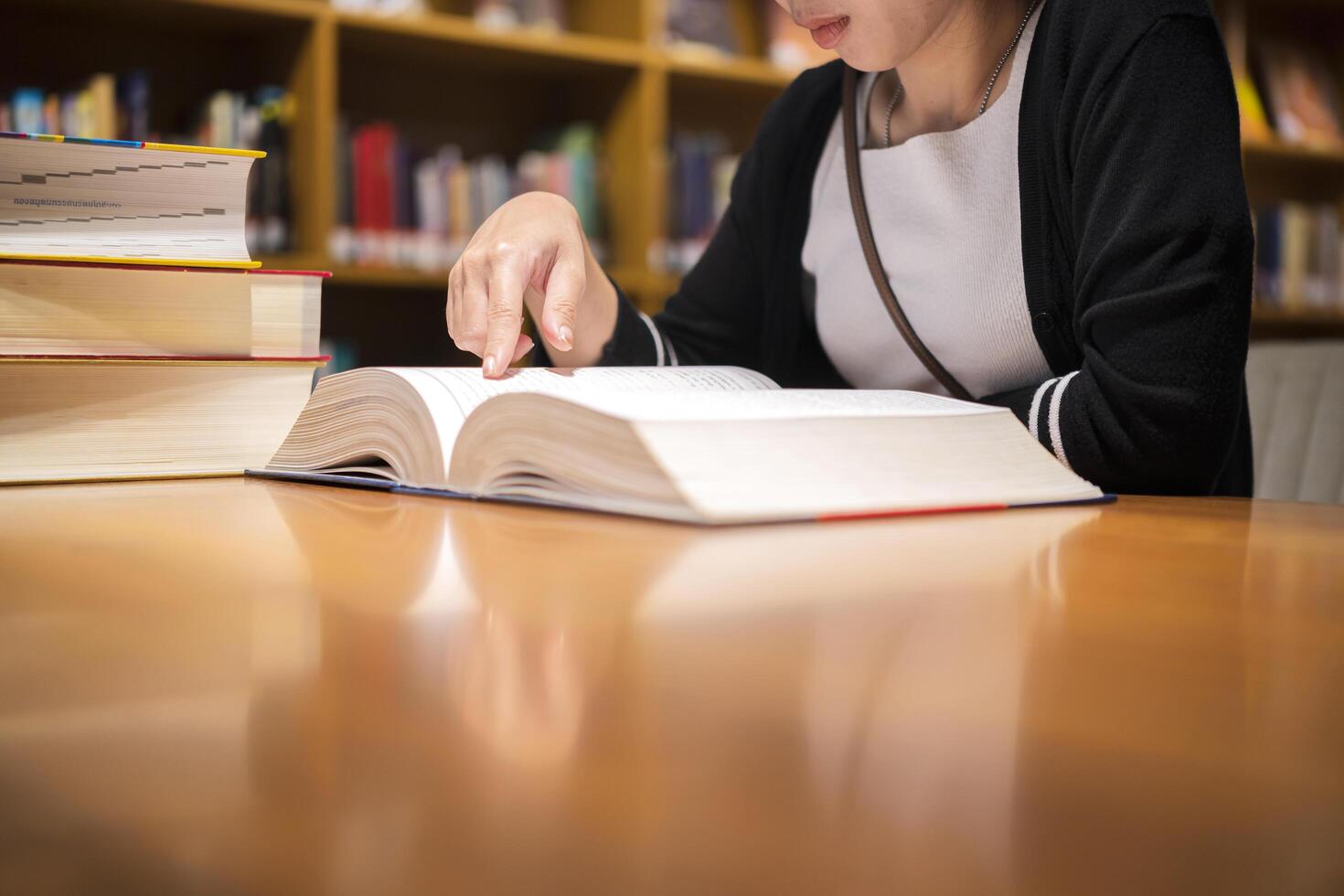 Cute Asian woman reading in a bookstore, to relax and educate herself photo