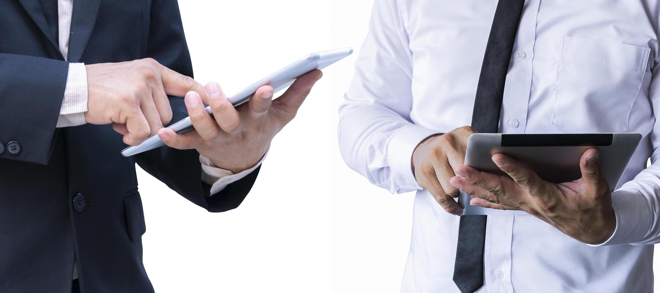 Business man standing on a white background isolated from the wall Use a tablet computer photo
