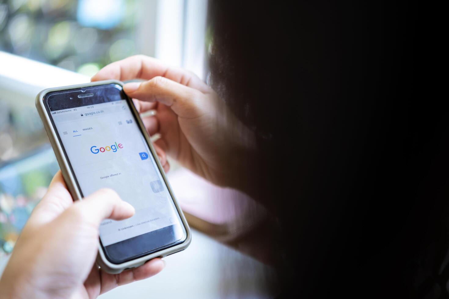 14 June 2020 Bangkok, Thailand. An Asian woman, she is using Google on her smartphone photo