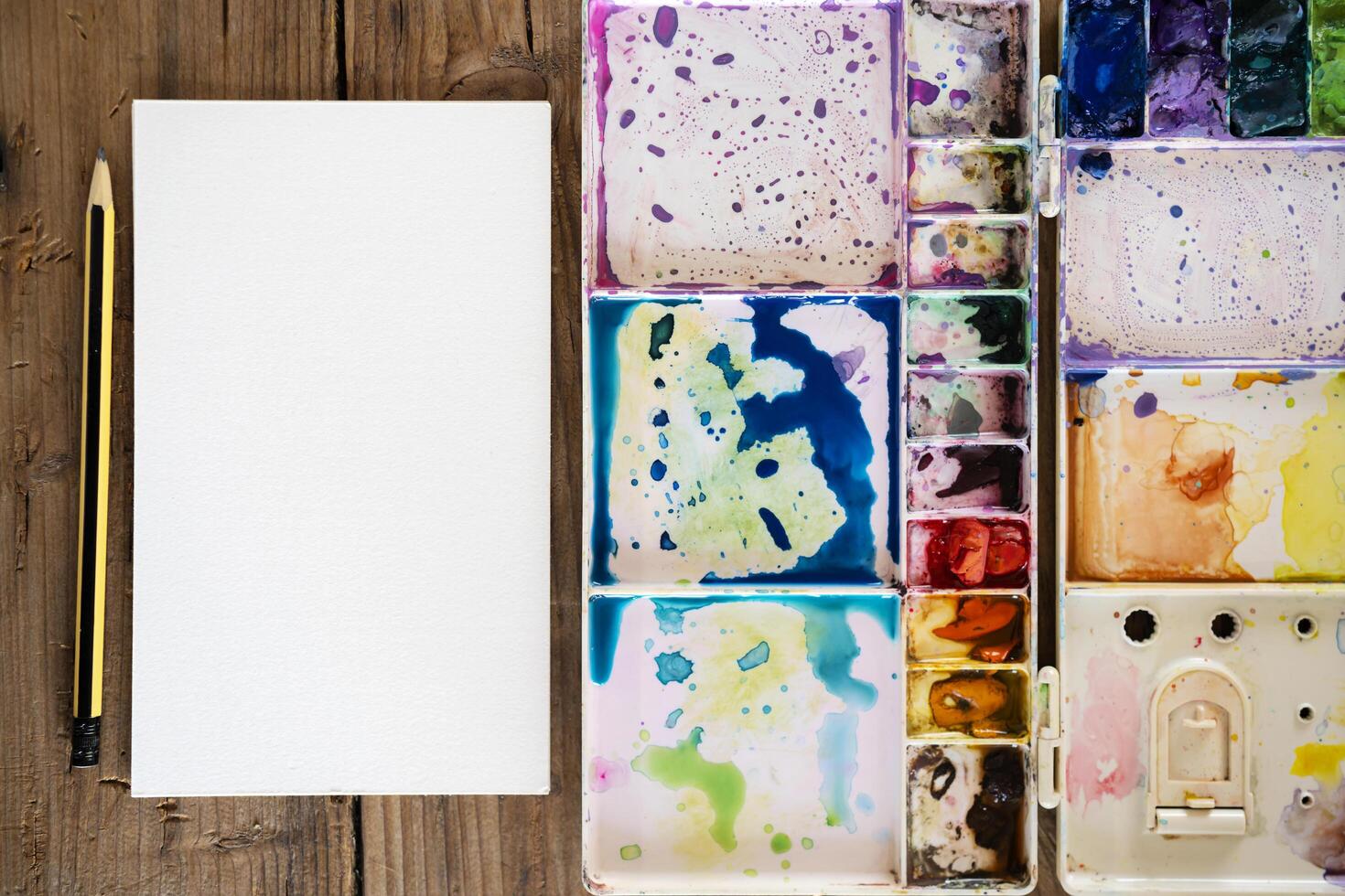The palette water paints on the table, many color in the palette water paints photo