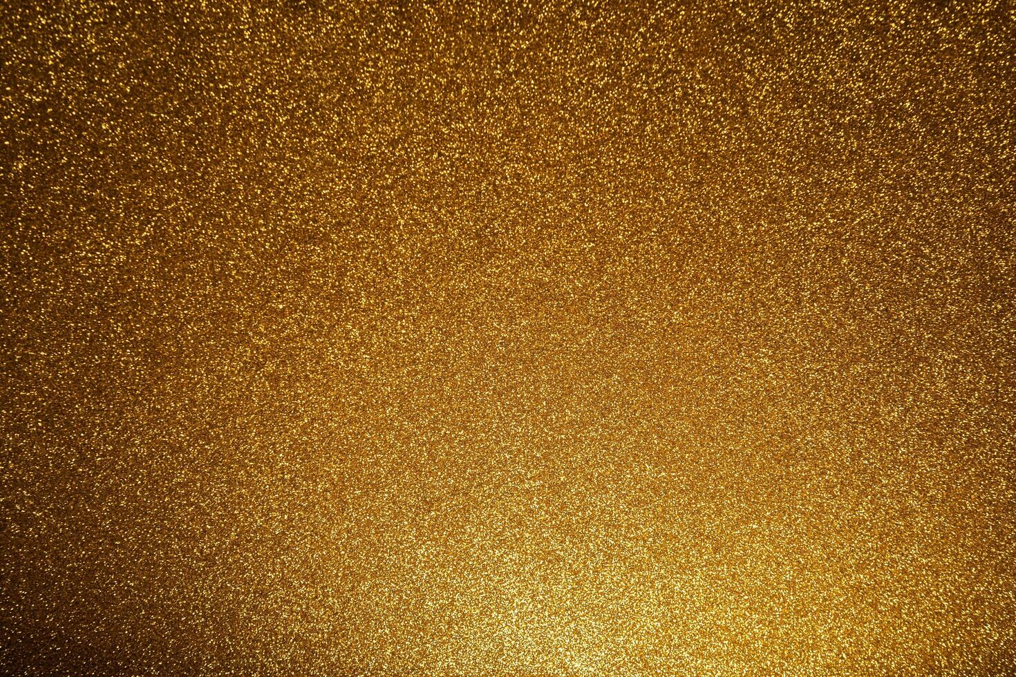 gold Sparkling Lights Festive background with texture. Abstract Christmas twinkled bright bokeh defocused and Falling stars. photo