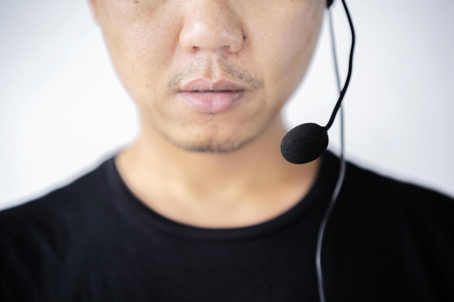Customer call center service care digital technology connect with work concept. New gen leadership look. Young business asian man using headphone for support. White background photo